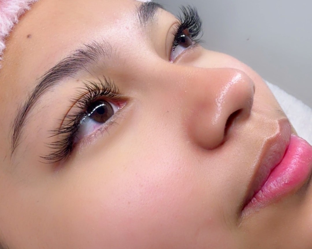 Client with fluffy lash extensions by Mayluxe Beauty Co